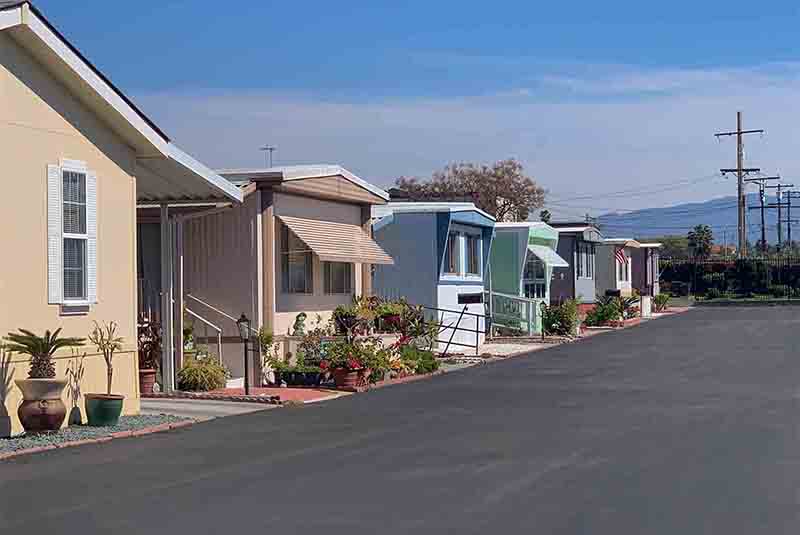View of row of mobile homes in trailer park.